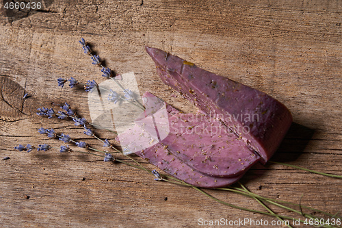 Image of Lavender cheese with bunch of fresh lavender flowers on rough wooden planks