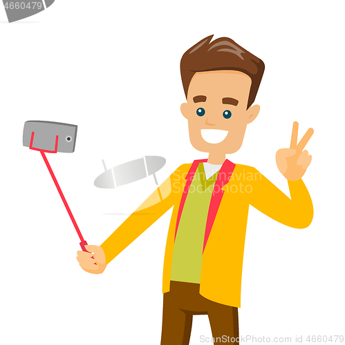 Image of A white man making selfie on his cellphone with a selfie stick.