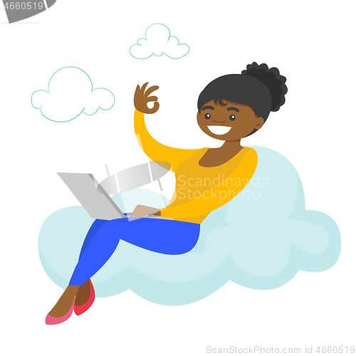 Image of A woman on a cloud working on a laptop and showing ok sign.