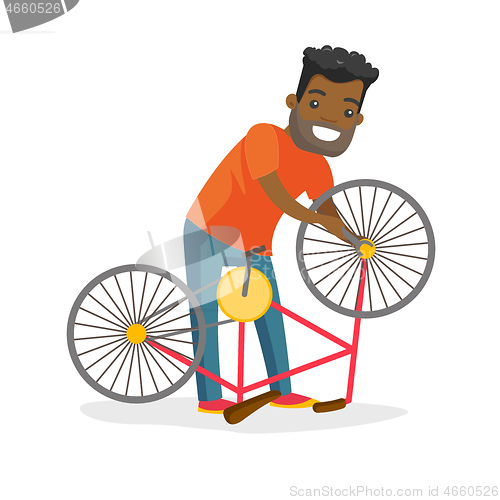 Image of Black man working in the bike workshop.
