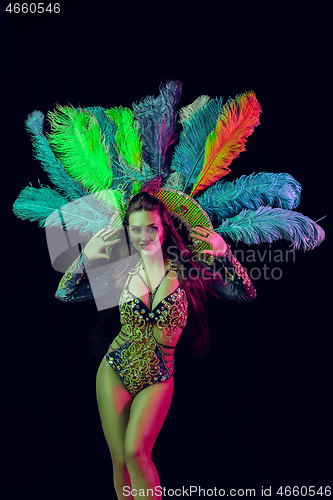 Image of Beautiful young woman in carnival peacock costume