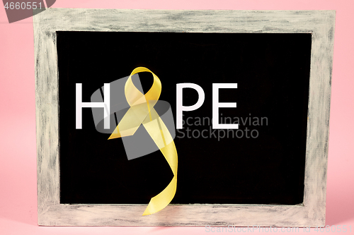 Image of Yellow ribbon symbolic color for Sarcoma Bone cancer awareness and suicide prevention