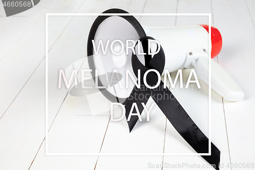 Image of Black ribbon-symbol of fight against melanoma and skin cancer.