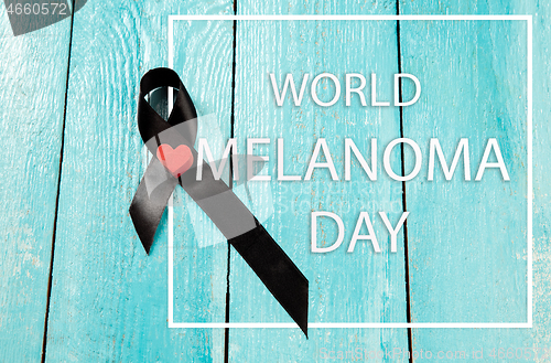 Image of Black ribbon-symbol of fight against melanoma and skin cancer.