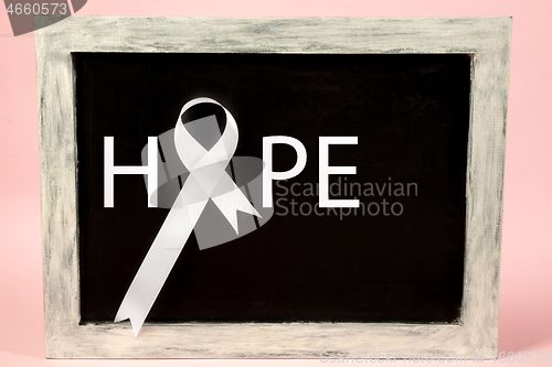 Image of lung cancer ribbon, white ribbon, a symbol of the fight against lung cancer