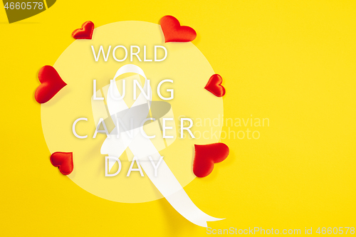 Image of lung cancer ribbon, white ribbon, a symbol of the fight against lung cancer