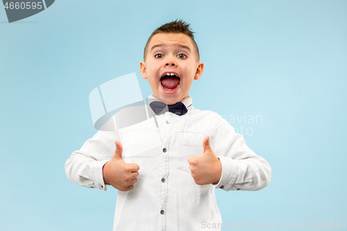 Image of Isolated on blue young casual boy shouting at studio