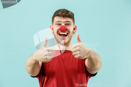 Image of Happy man on red nose day.