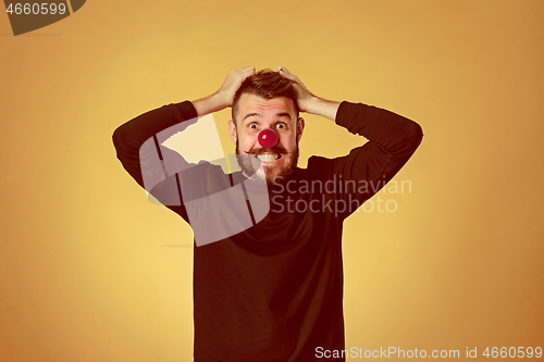 Image of Happy man on red nose day.