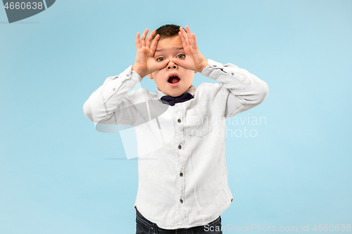 Image of Portrait of the scared teen boy on blue