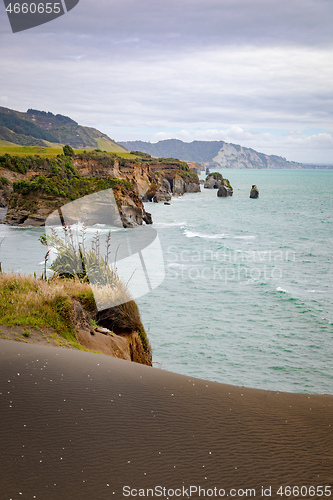 Image of sea shore rocks and mount Taranaki, New Zealand