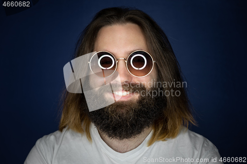 Image of bearded young man with long hair and sunglasses