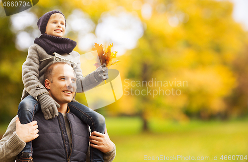 Image of happy family having fun in autumn park