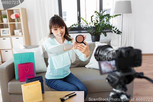 Image of female beauty blogger making video about make up