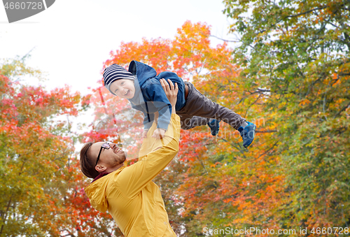 Image of father with son playing and having fun in autumn