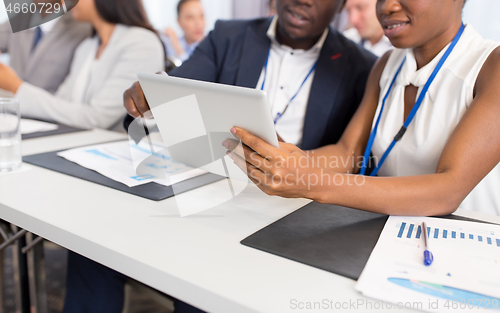 Image of people with tablet computer at business conference