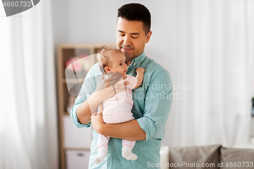 Image of middle aged father with baby daughter at home