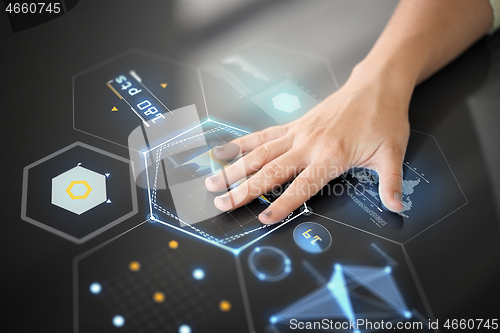 Image of hand using black interactive panel with charts