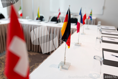 Image of flags at international conference boardroom