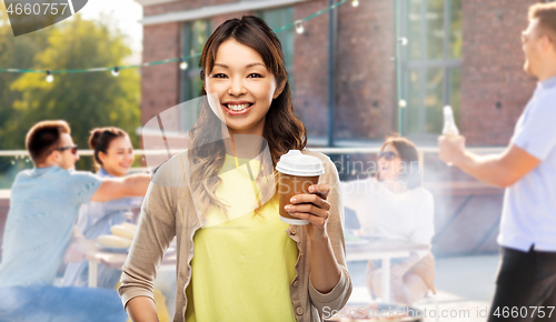 Image of asian woman drinking coffee over rooftop party