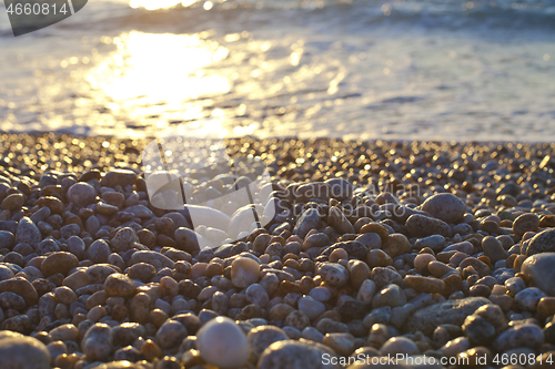 Image of Beautiful seascape, amazing view of pebble coastline in mild sun