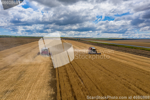 Image of Aerial view of combine on harvest field