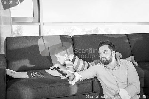 Image of Happy Young Family Playing Together on sofa