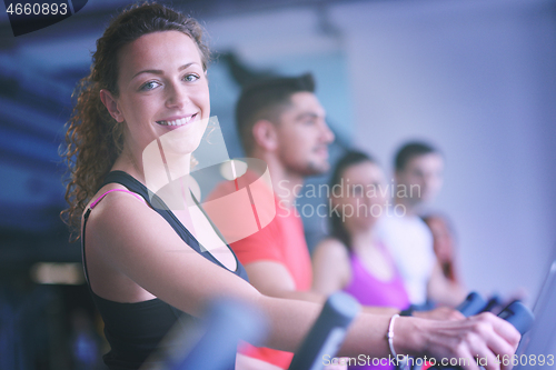 Image of Group of people running on treadmills