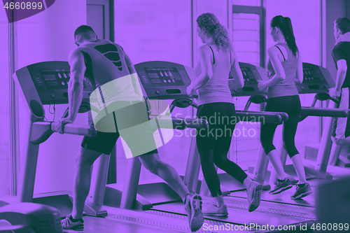 Image of Group of people running on treadmills