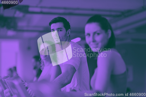 Image of Group of people running on treadmills