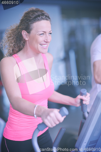 Image of woman exercising on treadmill in gym