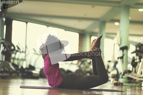 Image of african american woman exercise yoga in gym