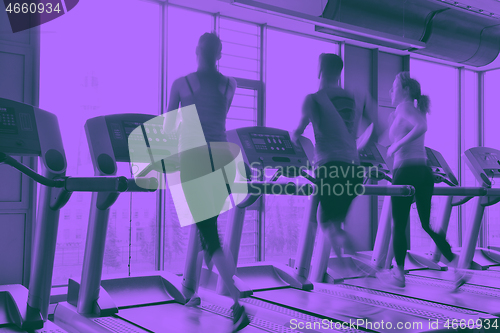 Image of Group of people running on treadmills