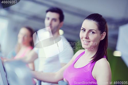 Image of Group of people running on treadmills