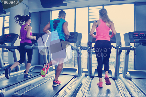 Image of Group of people running on treadmills