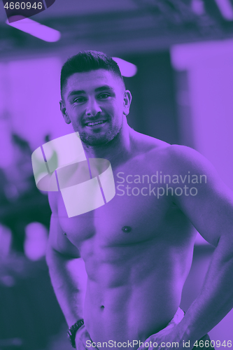 Image of handsome man exercising at the gym