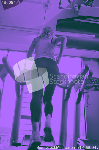 Image of woman exercising on treadmill in gym