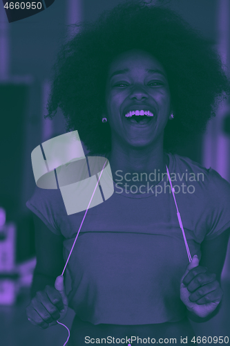 Image of afro american woman running on a treadmill