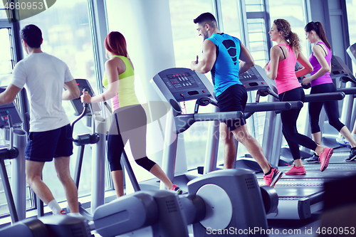 Image of Group of people running on treadmills