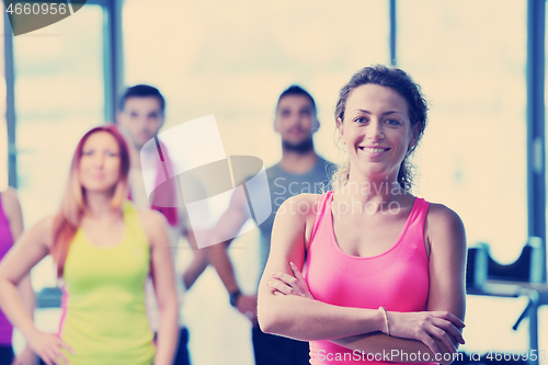 Image of Group of people exercising at the gym