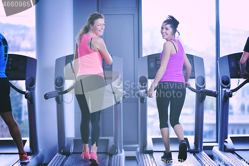 Image of Group of people running on treadmills