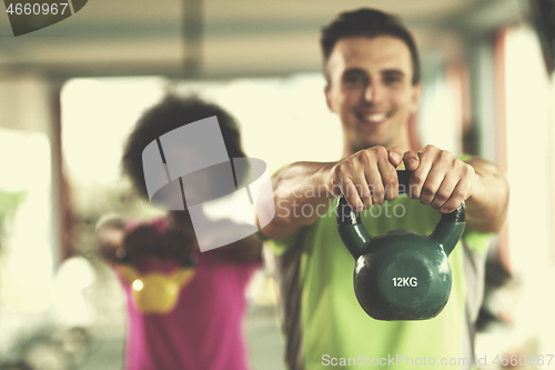 Image of couple  workout with weights at  crossfit gym