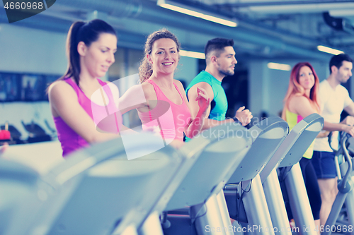 Image of Group of people running on treadmills