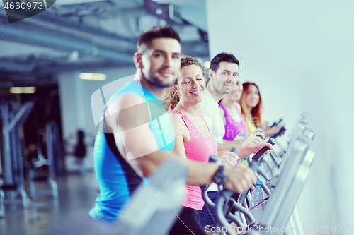 Image of Group of people running on treadmills