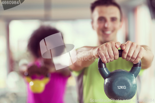 Image of couple  workout with weights at  crossfit gym