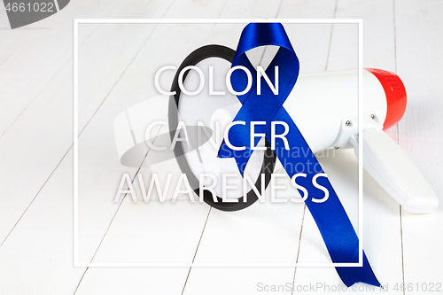 Image of Colon cancer awareness poster. Blue ribbon made of dots on white background. Medical concept.