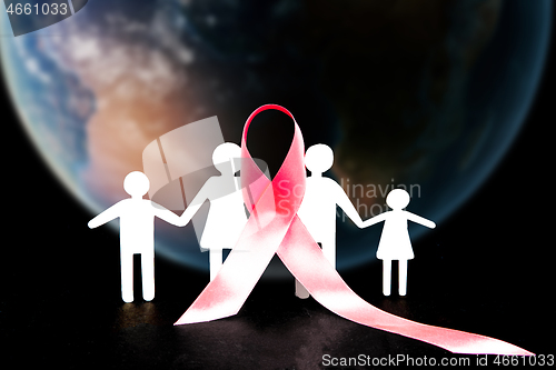 Image of The composition with pink ribbon on a table background