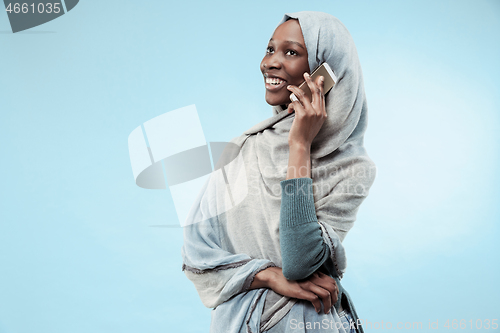 Image of The beautiful young black muslim girl wearing gray hijab, with a happy smile on her face.