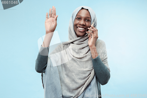 Image of The beautiful young black muslim girl wearing gray hijab, with a happy smile on her face.