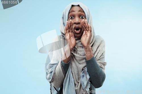 Image of Isolated on blue young africasual woman shouting at studio